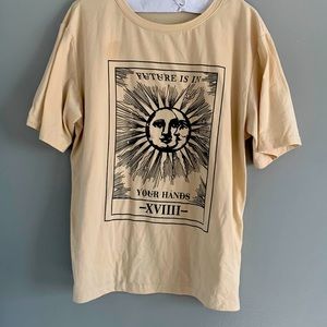 Tan tarot card graphic tee with the sun and moon on it